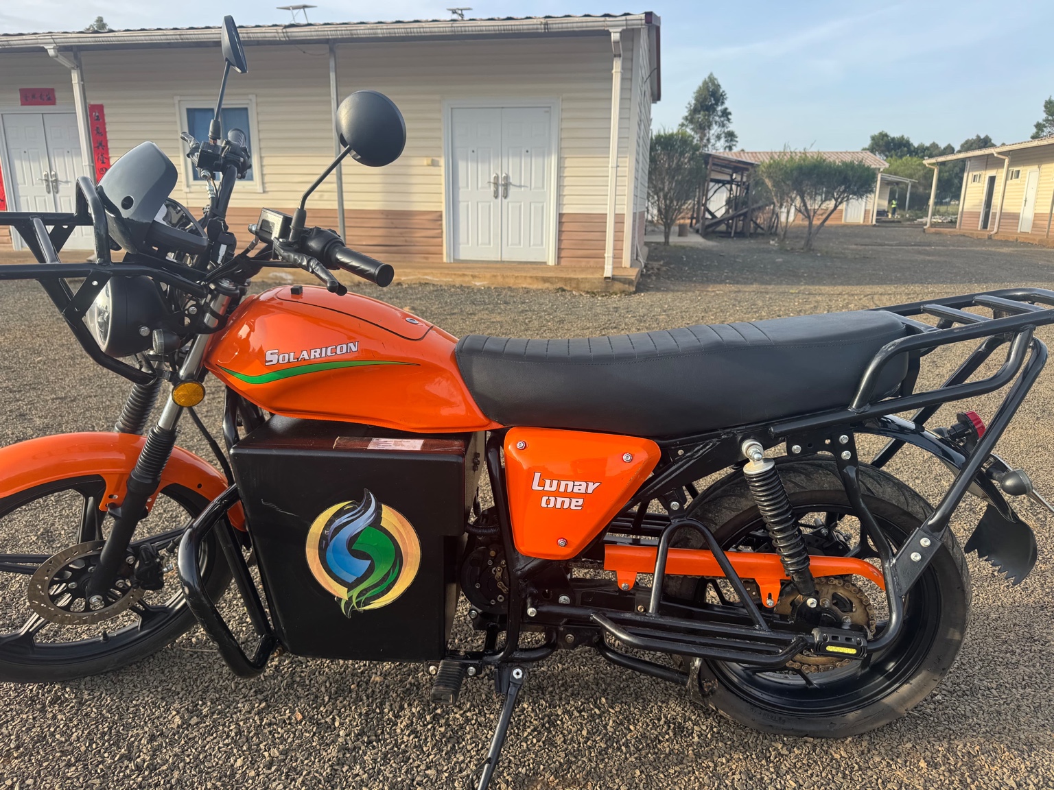 Orange LUNAR ONE motorcycle shown in side profile
